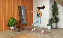 Woman working out in front of a mirror