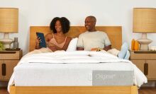 A woman and man sitting on Casper Original Queen Mattress