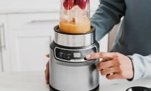 Man presses button on Ninja personal blender 