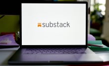 An open laptop displaying the Substack logo.