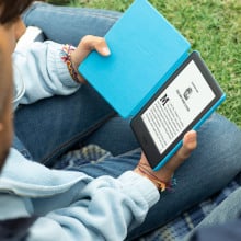 child holding kindle paperwhite kids e-reader