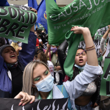 People celebrate Colombia's decision to decriminalize abortion, waving green flags and cheering.