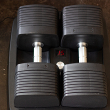 set of adjustable dumbbells with number 15 on LED panel