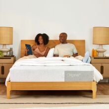 A woman and man sitting on Casper Original Queen Mattress