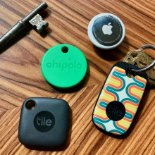 Four different bluetooth trackers on a wood table