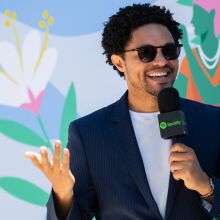 Trevor Noah holding a Spotify microphone.