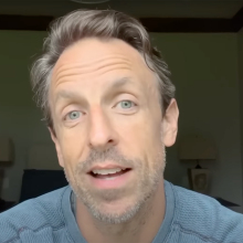 A man sits in a room talking to the camera.