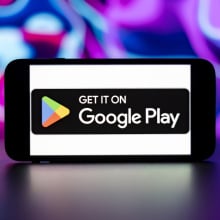 Google play store logo is seen displayed on a mobile phone screen.