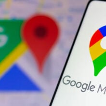 The Google Maps logo seen displayed on a smartphone and in the background.