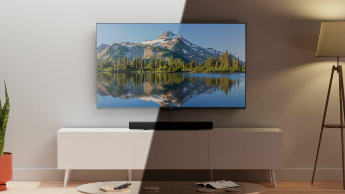 Amazon QLED TV on TV stand with light hitting half of the TV