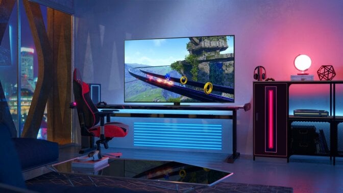 Samsung TV in room with colorful LED lights near gaming chair