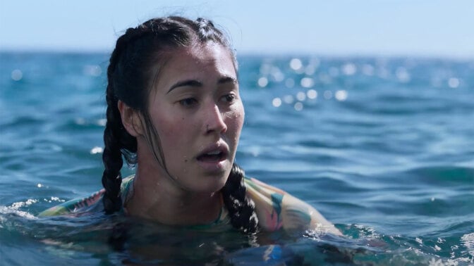 A woman floats in the water.