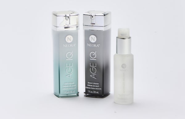 Neora’s Age IQ Night and Day Cream bottles next to a Sig Serum bottle.