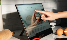 person using portable monitor on countertop in kitchen