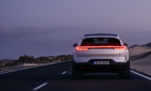 Polestar SUV driving on road beside body of water