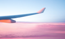 close up of wing of plane in sky