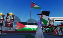 A screenshot from inside the experience. A large Palestinian flag is seen in the background.