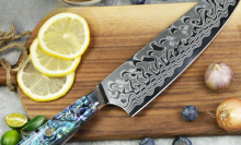 Ryori chef knife laying on cutting board with fruits and vegetables