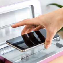 a person placing a phone into the phonesoap 3