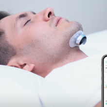 man laying down with snore circle device and app