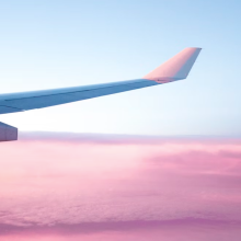 close up of wing of plane in sky