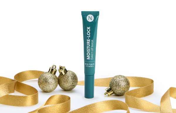 A Neora Moisture-Lock Lip Mask tube surrounded by gold ribbon and ornaments.